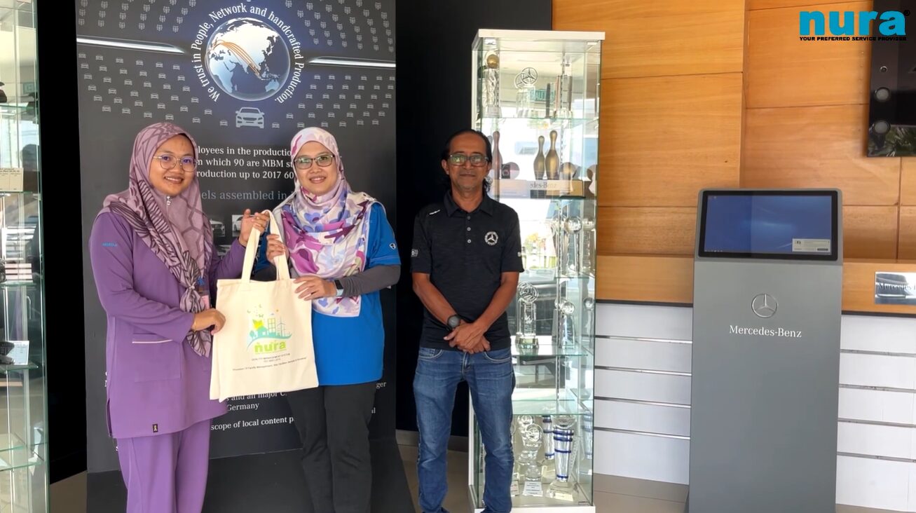 NURA team with a satisfied Mercedes-Benz Malaysia client, showcasing successful commercial cleaning partnership