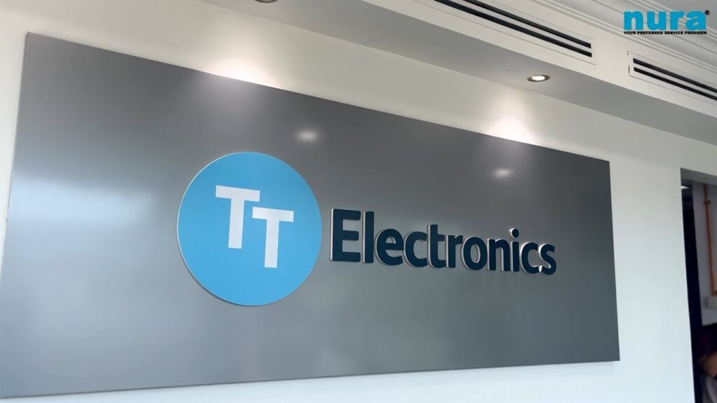 obby sign for TT Electronics, with the NURA logo visible, showcasing the client partnership for fast and professional industrial cleaning services.